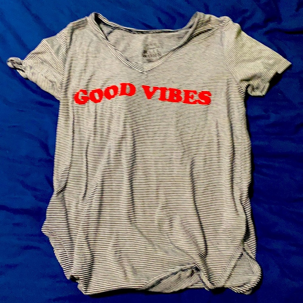 It is a grey and red shirt size L